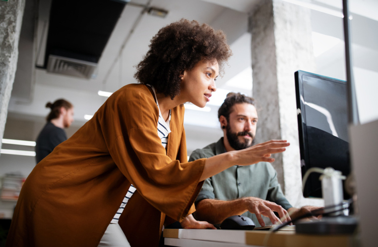 Women And Man Reviewing Data In Office