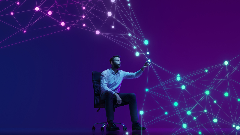 Man pointing at a dot in an interconnected graph.